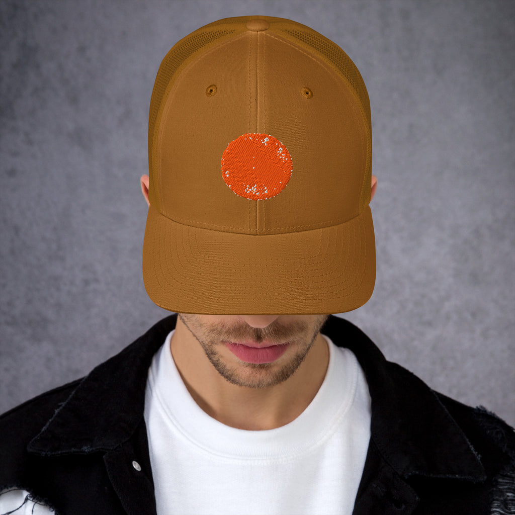 Caramel Be Reem Circle Trucker Cap featuring a classic mesh back and curved brim.