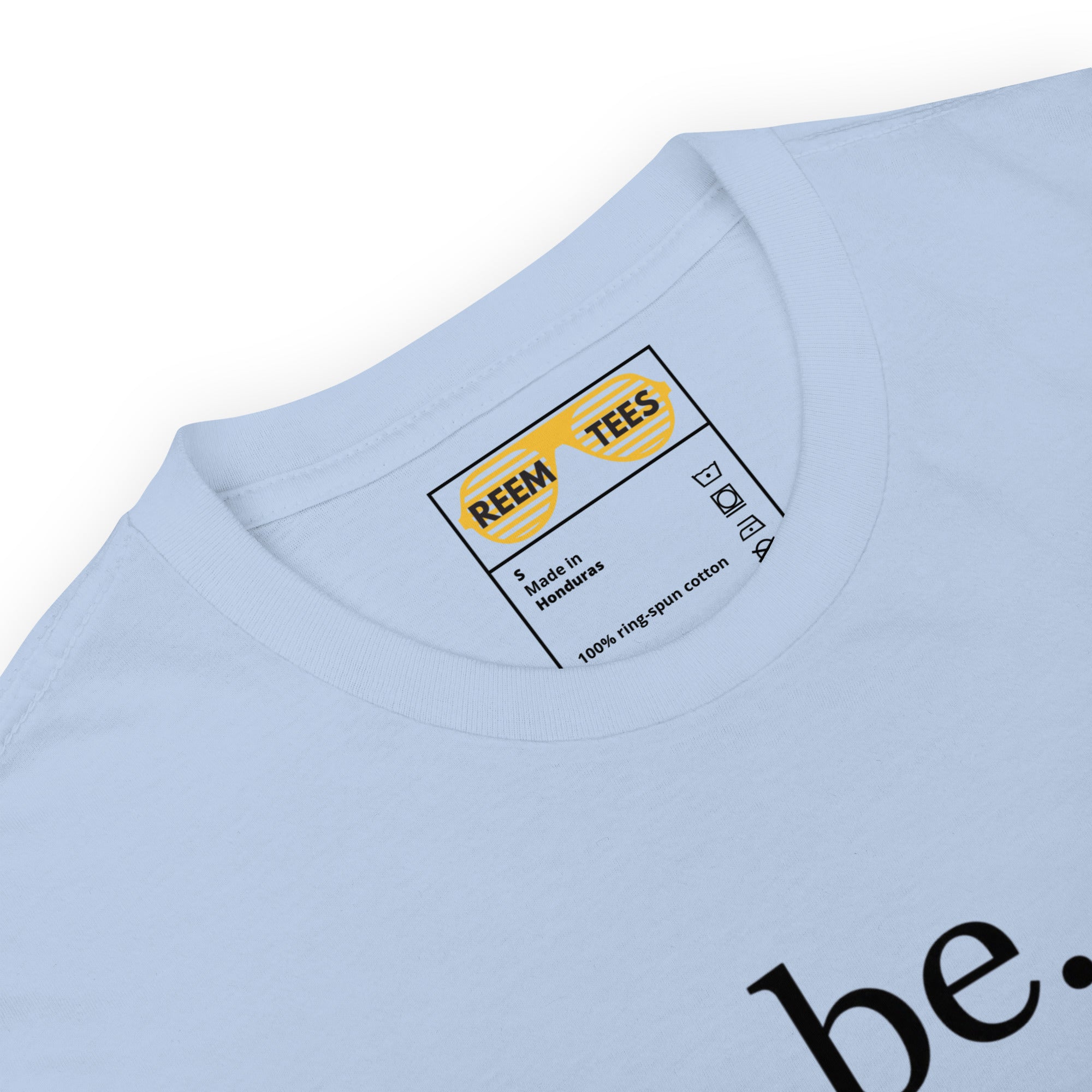 Light blue short-sleeve unisex t-shirt featuring the Be Reem Les Lalanne dark logo by Reem Tees.